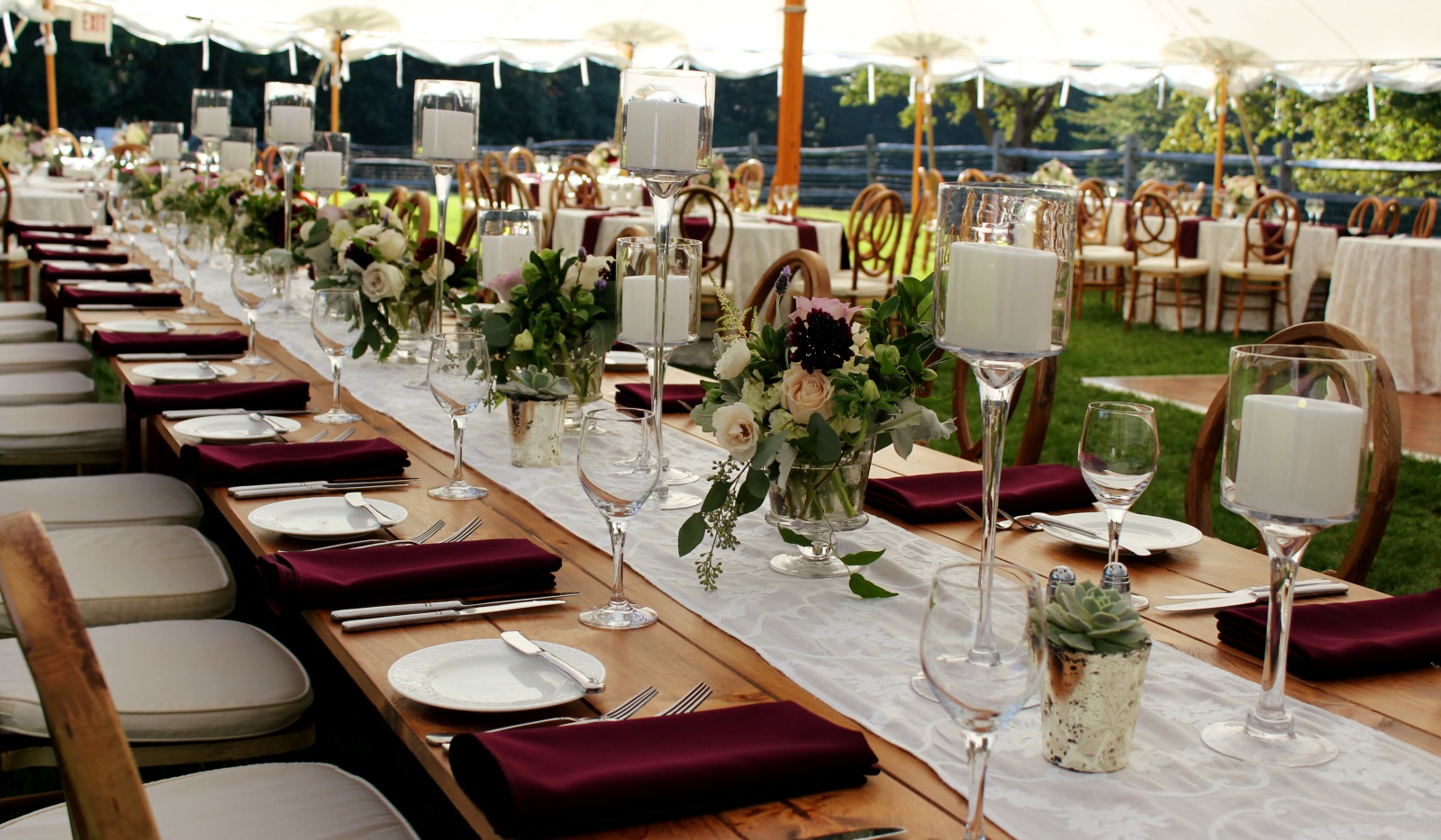 Long table set for large event under tent. 