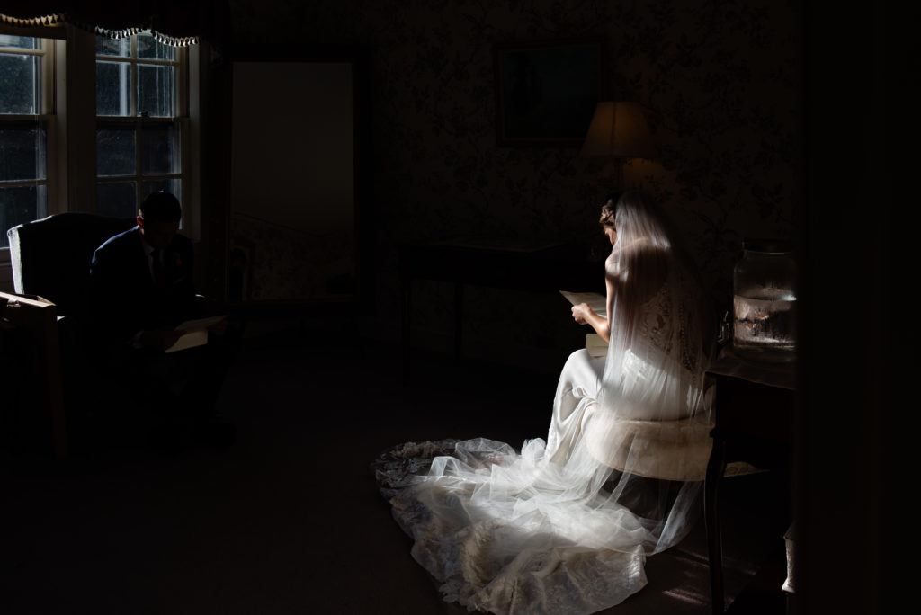 The bride has a quiet moment in the bridal suite. 